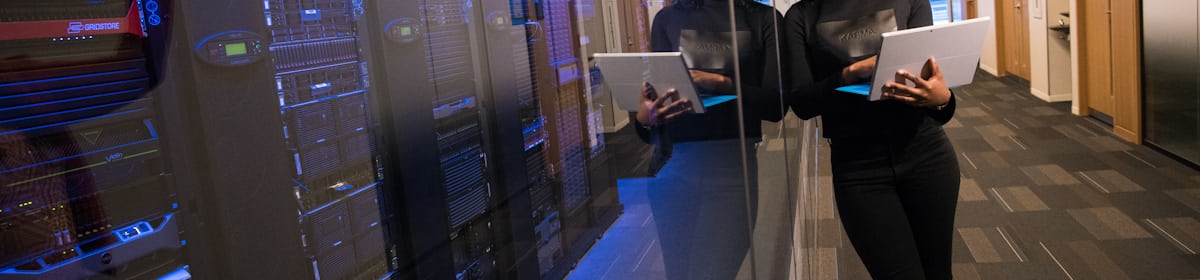 Team reviewing operations data on a server room floor